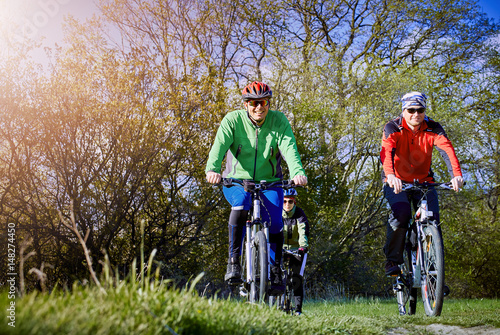 Walking a bike through the forest in the spring.