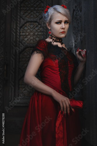 Woman in vintage red dress with lace.