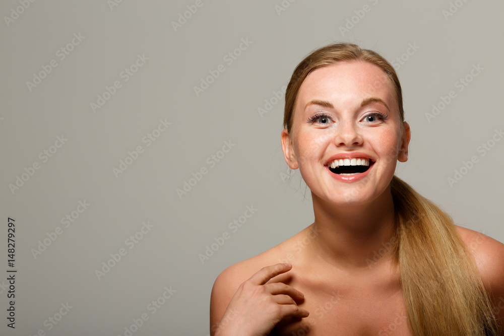 Smiling woman on gray background Smiling woman on gray background