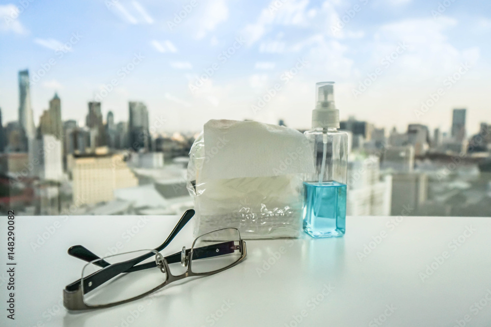 man glasses on the office desk with alcohol bottle backdrop for sanitary man glasses on the office desk with alcohol bottle backdrop for sanitary