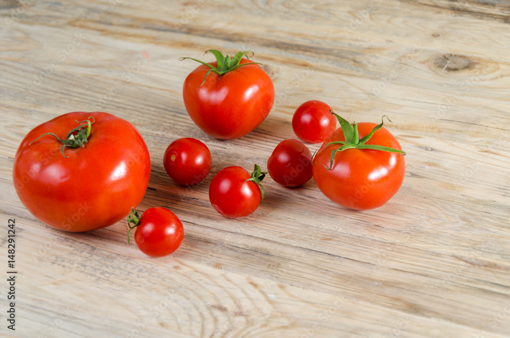 Composition from a tomato on a wooden background. Composition from a tomato on a wooden background.