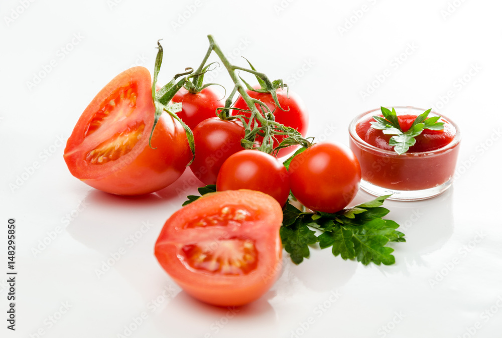 Composition from a tomato and ketchup on a white background. Composition from a tomato and ketchup on a white background.