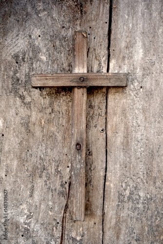 old wooden cross on a wooden background