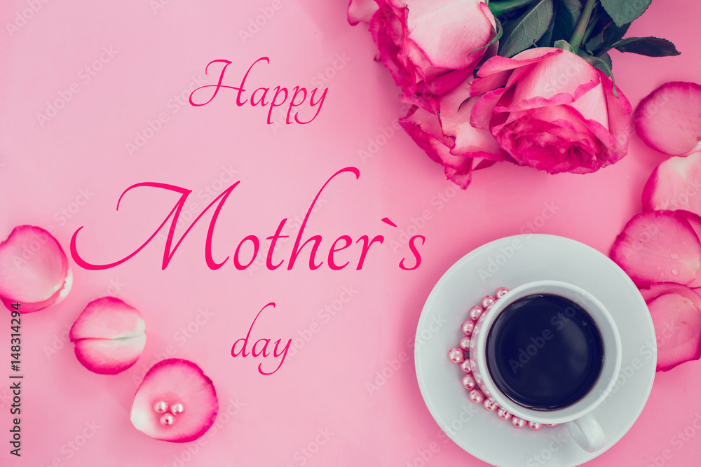 Happy Mother`s day concept bouquet of pink roses on a pink background and cup of coffee Top view Happy Mother`s day concept bouquet of pink roses on a pink background and cup of coffee Top view