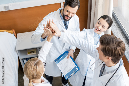 doctors team giving highfive