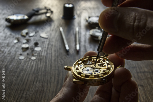 Watchmaker is working in their workshop