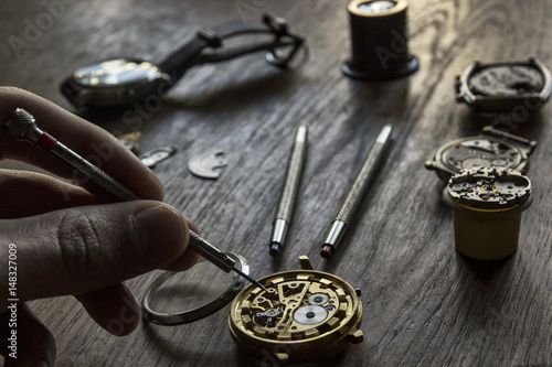 Watchmaker is working in their workshop