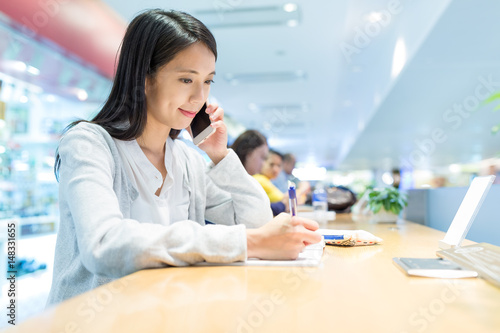 Woman writing on the note