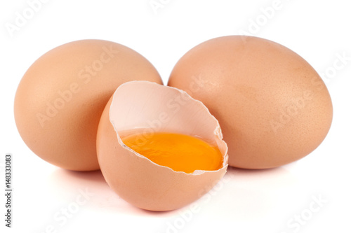 two whole eggs and broken egg isolated on white background