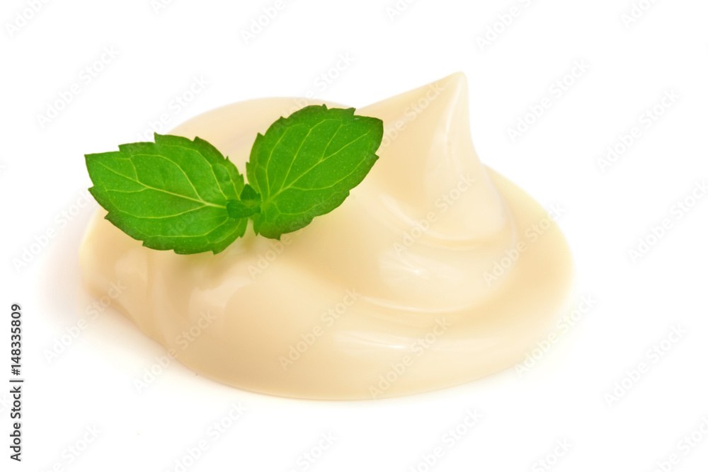 Mayonnaise swirl with a mint leaf isolated on a white background close-up Mayonnaise swirl with a mint leaf isolated on a white background close-up