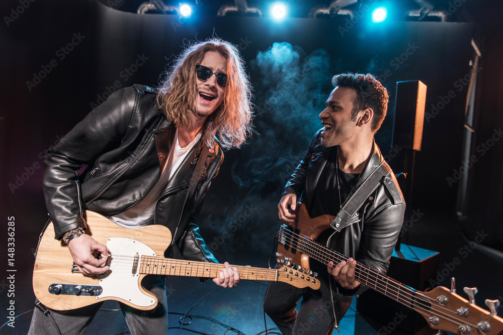 Obraz premium Electric guitar players performing hard rock music on stage