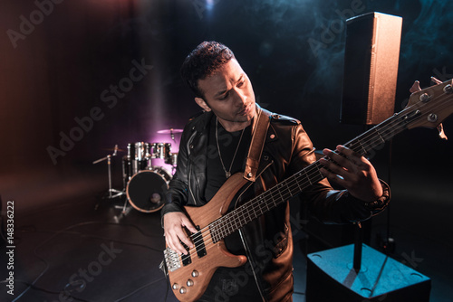 Electric guitar player performing hard rock music with bass guitar on stage photo