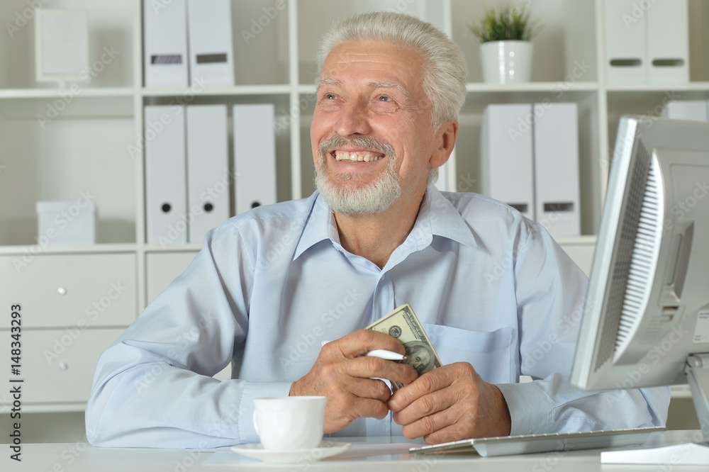 Old businessman with a laptop working Old businessman with a laptop working