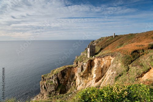 Engine houses perched dramatically on the edge of cliffs at Rinsey near Porthleven in Cornwall