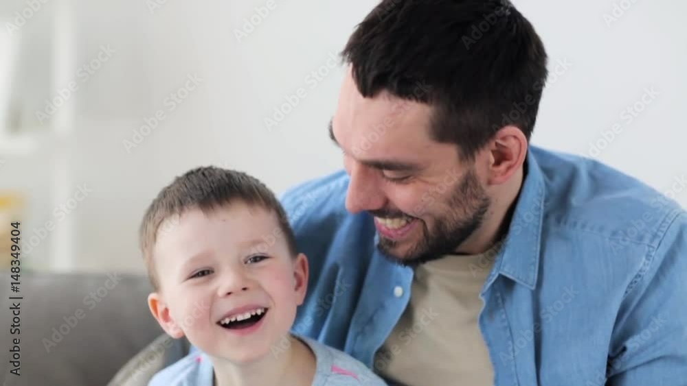 happy father and little son laughing at home happy father and little son laughing at home