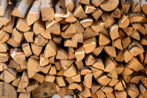 firewood background - split hardwood kiln-dried. split firewood in the stack. photo