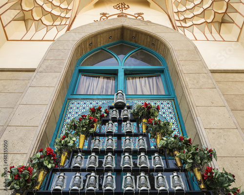 kerosene lamps and artificial flowers in front of a mosque, as a symbol of mourning of Imam Husayn martyrdom in the Battle of Karbala, Tehran, Iran photo