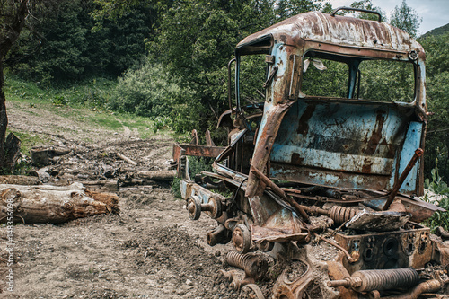 Broken tractor in a wild forest. Vintage