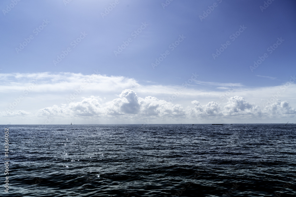 Cumulus Clouds On Seaside Horizon