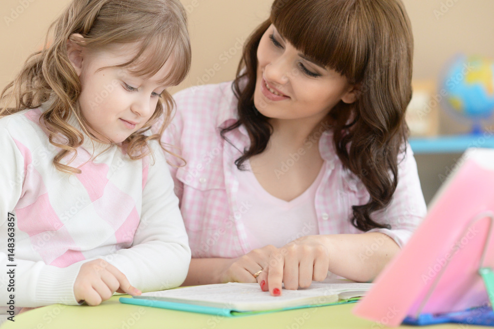 Mother and daughter doing lessons Mother and daughter doing lessons