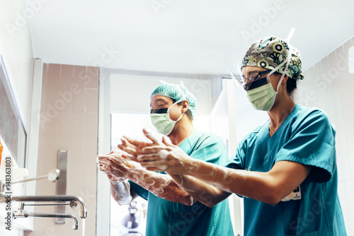 Couple of Surgeons Washing Hands Before Operating.