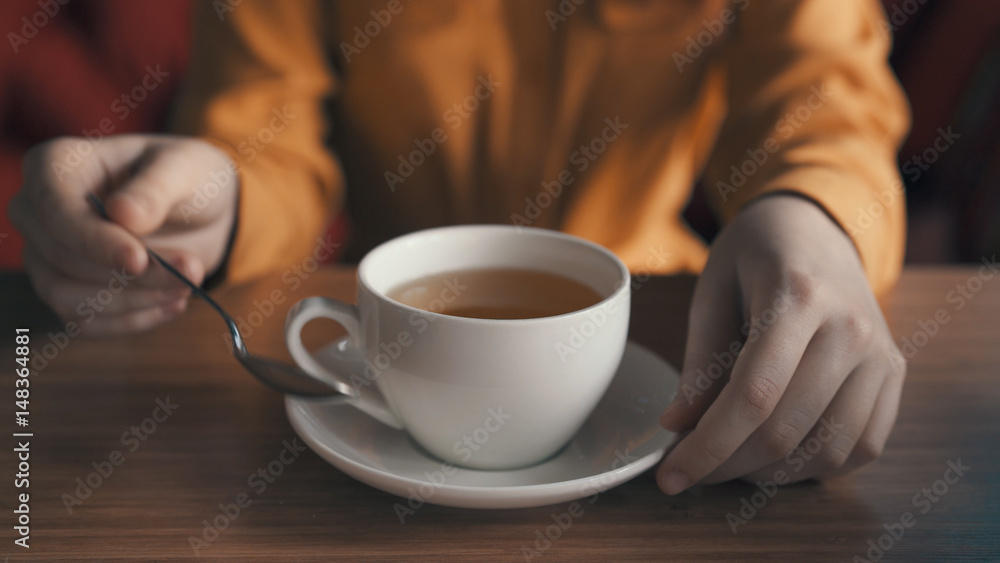 a cup of tea, a small spoon, breakfast a cup of tea, a small spoon, breakfast