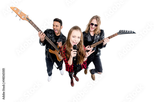 singer with microphone and musicians with electric guitars isolated on white, rock and roll band concept