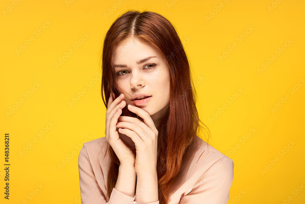 beautiful, red-haired, confident woman on a yellow background beautiful, red-haired, confident woman on a yellow background