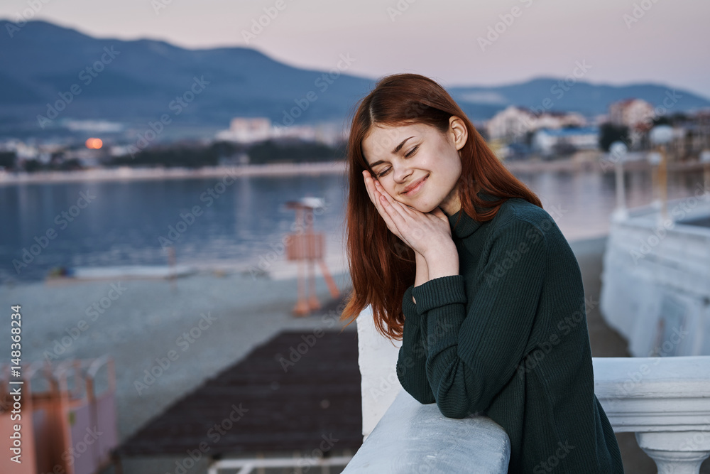 happy woman resting near the sea, emotions, fresh air