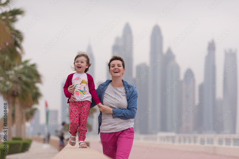 mother and cute little girl on the promenade