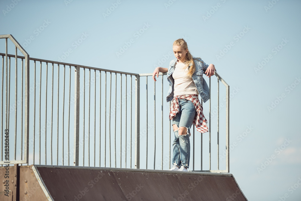 stylish teenage girl at skateboard park, hipster style concept