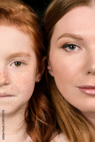 Cropped shot of beautiful mother and daughter looking at camera