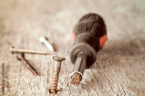 Old screwdriver and rusty screws