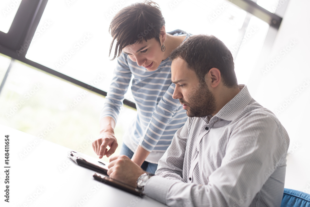 Fototapeta premium Two Business People Working With Tablet in startup office