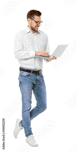Handsome young man with lap...