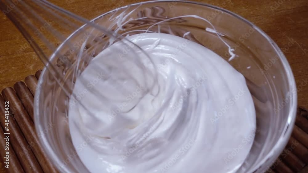 Beaten eggs with sugar using a mixer. Slow motion with rotation tracking shot. Beaten eggs with sugar using a mixer. Slow motion with rotation tracking shot.