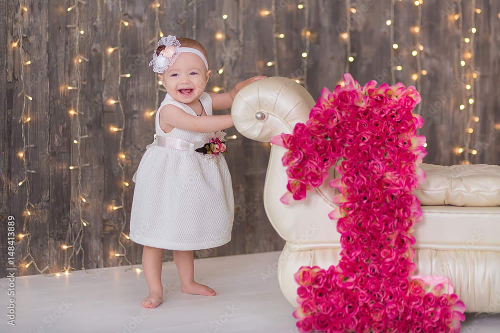 Cute baby girl 1-2 year old sitting on floor with pink balloons in room  over white. Isolated. Birthday party. Celebration. Happy birthday baby,  Little girl with group ball. Play room. Stock Photo