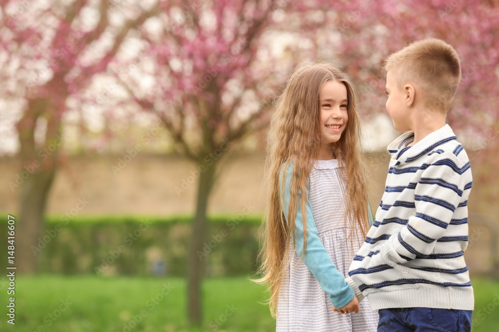 Fototapeta premium Pretty little girl and cute boy walking in spring park