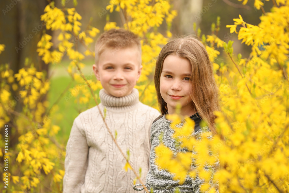Pretty little girl and cute boy walking in spring park Pretty little girl and cute boy walking in spring park