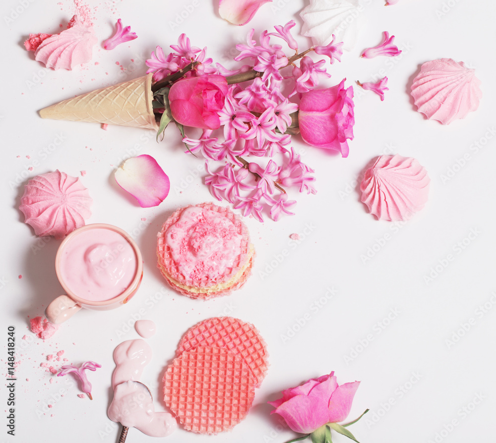 Flowers in a waffle cone with yogurt and meringues on white background Flowers in a waffle cone with yogurt and meringues on white background