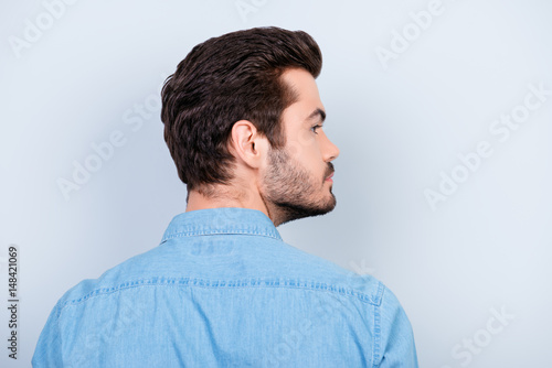 Εκτύπωση καμβά Back view of stylish young brunet man with modern hairstyle on light blue backgr