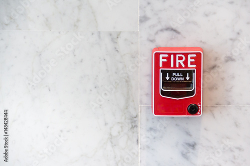 red firw alarm box on white marble background