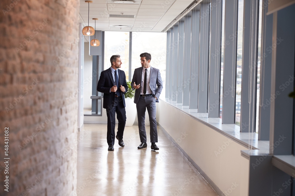 Two Businessmen Having Informal Meeting In Office Corridor Two Businessmen Having Informal Meeting In Office Corridor