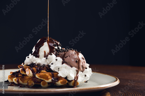 Ice cream with chocolate sauce and waffle