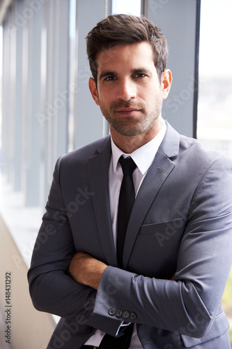 Head And Shoulders Portrait Of Young Businessman In Office