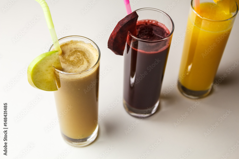 Healthy eating juicing cleanse diet trend concept - fruit and vegetable juice glasses with straw. Theme of raw food, live food background Healthy eating juicing cleanse diet trend concept - fruit and vegetable juice glasses with straw. Theme of raw food, live food background