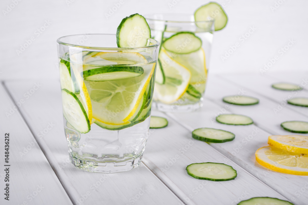 Refreshing cucumber cocktail, lemonade, detox water in a glasses on a white background. Summer drink. Refreshing cucumber cocktail, lemonade, detox water in a glasses on a white background. Summer drink.