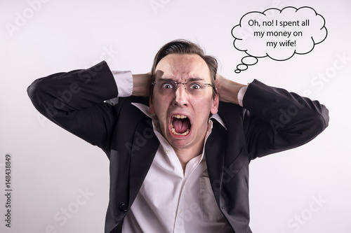 Fotografie Young businessman who spent all his money on his wife caprice screaming with rag