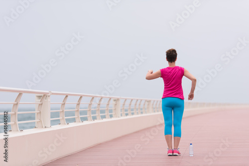 woman stretching and warming up on the promenade