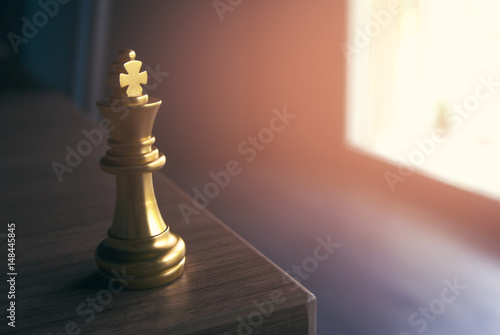 golden chess king on wood table